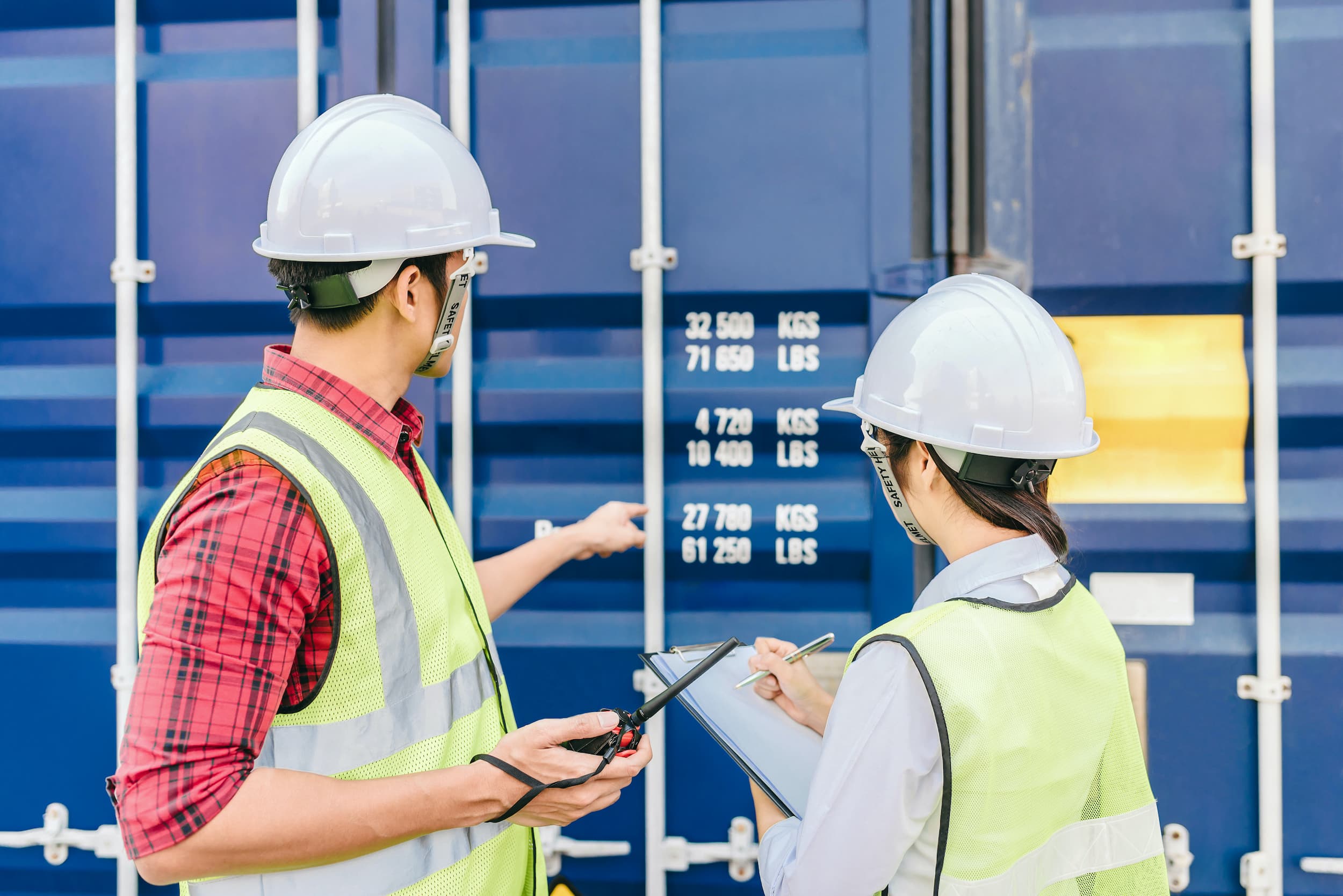 Foreman and staff checking shipping container details