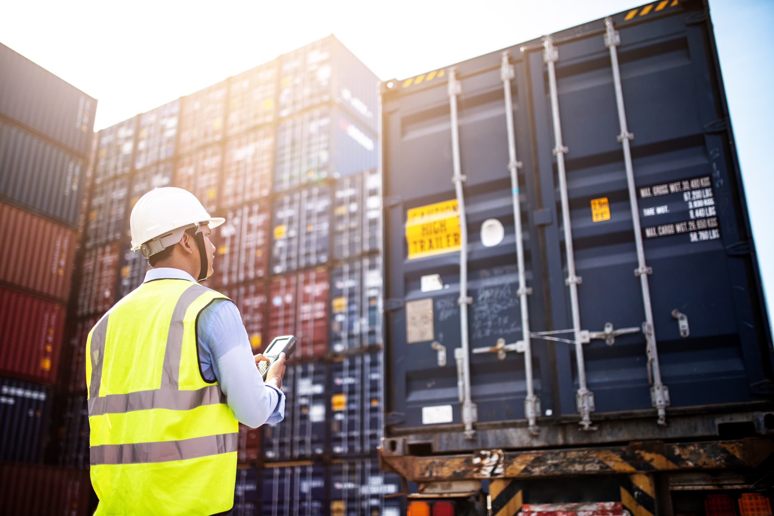 Foreman checking shipping containers at dock