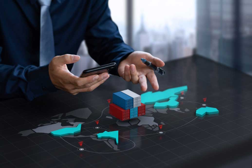 Man in office looking at containers on his desk with a map